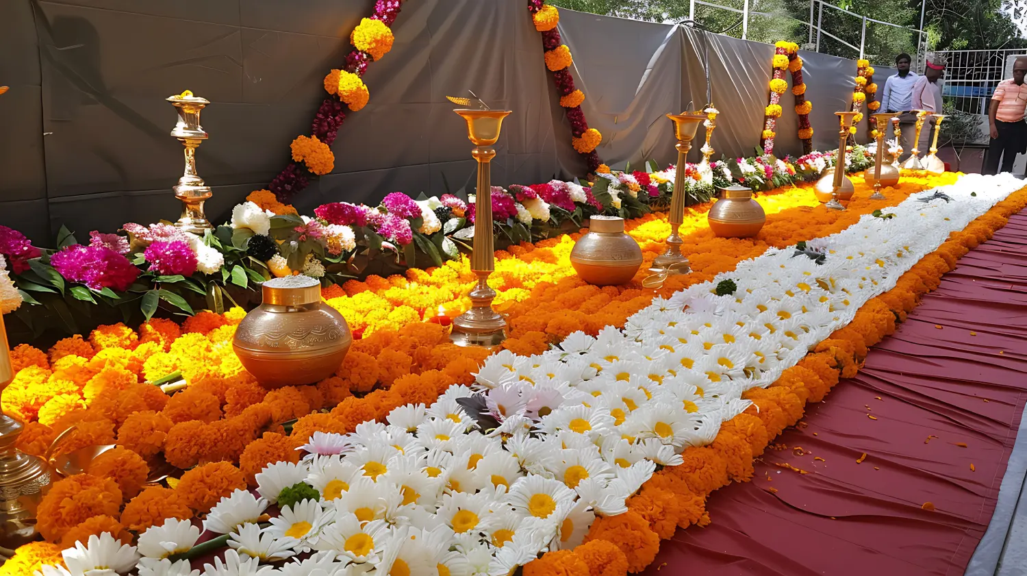 flowers candles are lined up table with red cloth